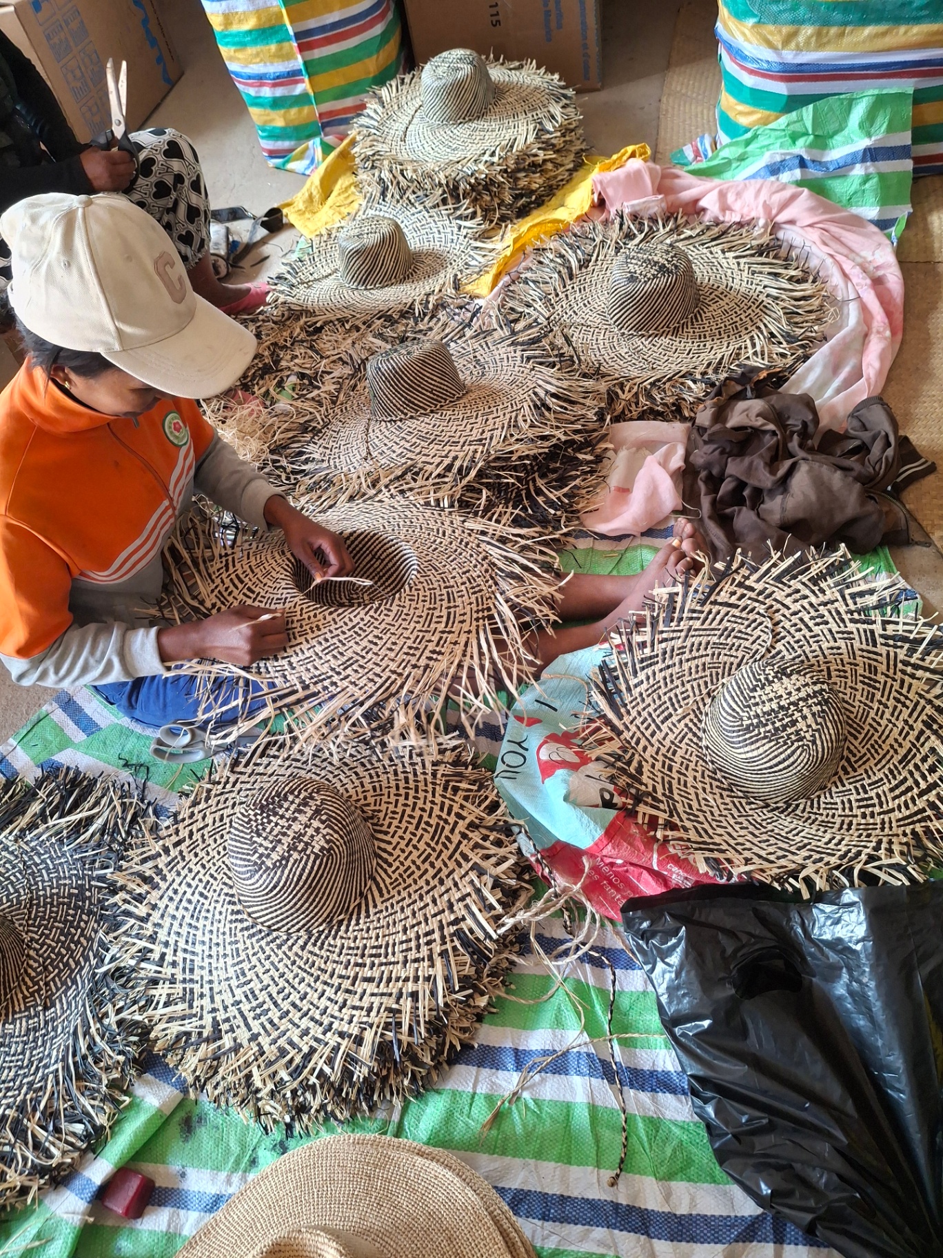 Women artisans weaving raffia in our Madagascar workshop
